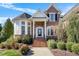 Charming two-story brick home with manicured lawn and inviting front entryway at 12409 Village Gate Way, Raleigh, NC 27614