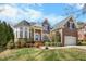 Charming two-story brick home with manicured lawn and attached two car garage at 12409 Village Gate Way, Raleigh, NC 27614