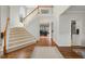 Elegant foyer with hardwood floors, staircase, and open view to living spaces at 12409 Village Gate Way, Raleigh, NC 27614
