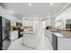 Spacious kitchen with white cabinets, granite countertops, stainless steel appliances, and tile flooring at 12409 Village Gate Way, Raleigh, NC 27614