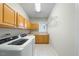 Functional laundry room features modern washer and dryer, plenty of cabinets, and countertop space at 12409 Village Gate Way, Raleigh, NC 27614