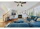Cozy living room with hardwood floors, fireplace, built-in shelving, and natural light from large windows at 12409 Village Gate Way, Raleigh, NC 27614