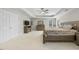 Primary bedroom with tray ceiling, neutral carpet, generous closet space, and natural light at 12409 Village Gate Way, Raleigh, NC 27614
