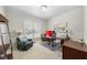 Bright home office features a large window, comfortable seating, and desk space at 12409 Village Gate Way, Raleigh, NC 27614