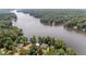 Scenic aerial shot of a lakefront property with lush trees and tranquil lake waters at 1315 Sagamore Dr, Louisburg, NC 27549
