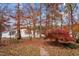 Backyard view in autumn with colorful trees leading to a serene lake and a glimpse of a boat house at 1315 Sagamore Dr, Louisburg, NC 27549