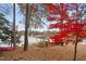 Lakefront property with vibrant trees, a private boat dock, and stunning water views at 1315 Sagamore Dr, Louisburg, NC 27549