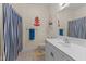 Cozy bathroom featuring a single vanity and blue-and-white striped shower curtain at 1315 Sagamore Dr, Louisburg, NC 27549