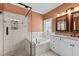 Modern bathroom featuring a separate shower and tub, dual sinks, and elegant finishes at 1315 Sagamore Dr, Louisburg, NC 27549