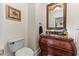 Cozy bathroom features a carved wood cabinet with a marble countertop and vintage mirror at 1315 Sagamore Dr, Louisburg, NC 27549