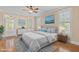 Bright bedroom with a ceiling fan, plush bedding, and hardwood floors at 1315 Sagamore Dr, Louisburg, NC 27549