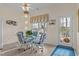 Charming dining area with glass table, wicker chairs, and natural light from the backyard at 1315 Sagamore Dr, Louisburg, NC 27549