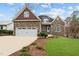 Stunning stone home with a two-car garage, well-maintained lawn, and charming curb appeal at 1315 Sagamore Dr, Louisburg, NC 27549