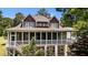 Elegant exterior view of a two-story home with a screened porch, perfect for outdoor relaxation at 1315 Sagamore Dr, Louisburg, NC 27549