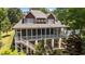 Charming exterior view of a two-story home with a spacious screened porch and deck at 1315 Sagamore Dr, Louisburg, NC 27549