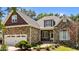 Well-lit stone house with landscaped yard and two-car garage at 1315 Sagamore Dr, Louisburg, NC 27549