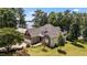 Beautiful stone home featuring a manicured lawn and stunning lake views at 1315 Sagamore Dr, Louisburg, NC 27549