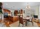 The bright kitchen features wood cabinets, stainless appliances, and an island adjacent to a dining area at 1315 Sagamore Dr, Louisburg, NC 27549