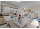 Bright kitchen with an island, white cabinets, and adjacent breakfast nook at 1315 Sagamore Dr, Louisburg, NC 27549