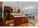 This bright kitchen boasts wood cabinets, stainless appliances, a speckled countertop island, and a nearby dining area at 1315 Sagamore Dr, Louisburg, NC 27549