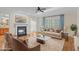 Elegant living room featuring a fireplace, hardwood floors, and large windows for plenty of natural light at 1315 Sagamore Dr, Louisburg, NC 27549