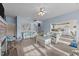 Spacious living room leading to a staircase and kitchen, with floral furniture and natural light at 1315 Sagamore Dr, Louisburg, NC 27549