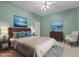 A bright main bedroom with two dressers, hardwood floors with a patterned rug, and a large king bed at 1315 Sagamore Dr, Louisburg, NC 27549