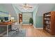 Bright and cozy office features hardwood floors, light green walls, built-in bookshelves, and a large window at 1315 Sagamore Dr, Louisburg, NC 27549