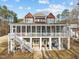 A spacious rear exterior of a lake house boasts a large screened porch for outdoor entertaining and serene relaxation at 1315 Sagamore Dr, Louisburg, NC 27549