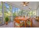 Inviting screened porch with wood furniture and views of the surrounding trees at 1315 Sagamore Dr, Louisburg, NC 27549