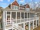 Elevated home showcases a large screened porch with white railings, perfect for enjoying outdoor living and views at 1315 Sagamore Dr, Louisburg, NC 27549