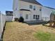 Fenced backyard with patio, playset, and partially dormant grass at 141 W Falcon Ct., Clayton, NC 27520