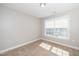 This is a bedroom with a large window that lets in natural light at 141 W Falcon Ct., Clayton, NC 27520