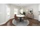 Bright dining room features a modern chandelier, a round table with seating, and lots of natural light at 141 W Falcon Ct., Clayton, NC 27520