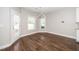 Bright dining area features hardwood floors, stylish lighting, and large windows for natural light at 141 W Falcon Ct., Clayton, NC 27520