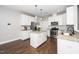 Modern kitchen with white cabinets, granite countertops, stainless appliances, and a center island at 141 W Falcon Ct., Clayton, NC 27520