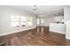 Expansive living room featuring dark wood floors, large windows, and an open layout at 141 W Falcon Ct., Clayton, NC 27520