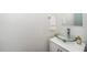 Modern powder room featuring a glass bowl sink, chrome faucet, and a white cabinet at 141 W Falcon Ct., Clayton, NC 27520