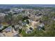 Aerial view of the property and surrounding neighborhood with mature trees at 1716 Turtle Ridge Way, Raleigh, NC 27614