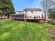 Expansive backyard featuring a large lawn, screened porch, and back deck at 1716 Turtle Ridge Way, Raleigh, NC 27614