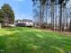 Beautiful backyard with a spacious lawn that leads to a screened porch and deck at 1716 Turtle Ridge Way, Raleigh, NC 27614