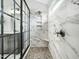 Beautiful bathroom with a luxurious shower featuring marble tiles, a mosaic floor, and black-framed glass at 1716 Turtle Ridge Way, Raleigh, NC 27614