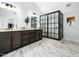 Modern bathroom featuring dual vanities, marble tile floors, and a frameless glass shower at 1716 Turtle Ridge Way, Raleigh, NC 27614