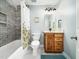 Stylish bathroom featuring a tiled shower, elegant vanity, and a decorative floral shower curtain at 1716 Turtle Ridge Way, Raleigh, NC 27614