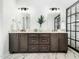 Elegant bathroom featuring a double vanity with marble countertops and a glass-enclosed shower at 1716 Turtle Ridge Way, Raleigh, NC 27614