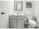 Compact bathroom featuring a simple vanity, toilet, and a clean, minimalist design at 1716 Turtle Ridge Way, Raleigh, NC 27614