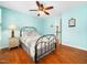 Charming bedroom with wood floors, a decorative ceiling fan, and light blue walls at 1716 Turtle Ridge Way, Raleigh, NC 27614