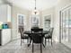Cozy dining area with a round table, tile flooring, and large windows offering plenty of natural light at 1716 Turtle Ridge Way, Raleigh, NC 27614