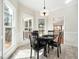 Charming dining area featuring tile floors, a black table set and access to a screened porch at 1716 Turtle Ridge Way, Raleigh, NC 27614
