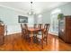 Traditional dining room with hardwood floors, chandelier, wainscoting, and ample natural light at 1716 Turtle Ridge Way, Raleigh, NC 27614